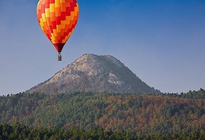 Hot air balloon flying over the mountains